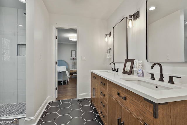 ensuite bathroom featuring tile patterned floors, walk in shower, a sink, and ensuite bathroom