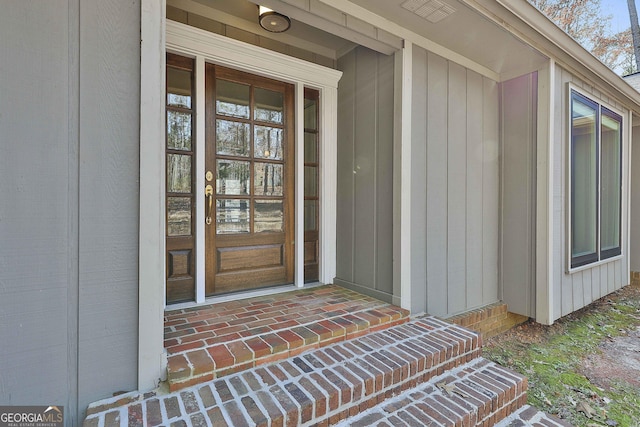 doorway to property featuring brick siding