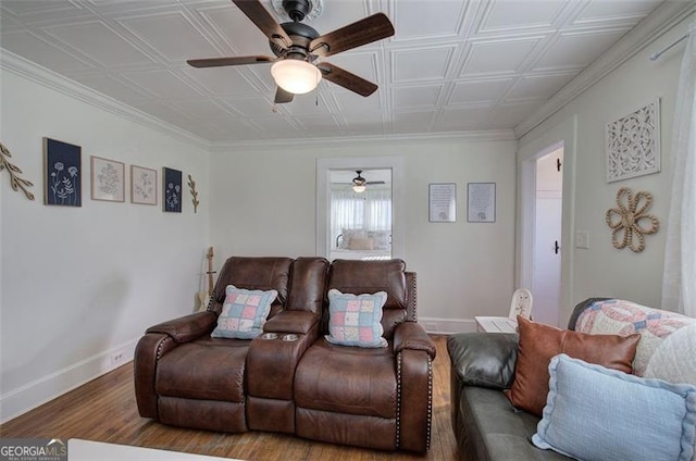 living room with an ornate ceiling, baseboards, and wood finished floors