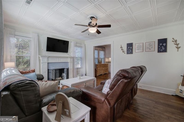 living area with an ornate ceiling, dark wood-type flooring, a fireplace, and baseboards