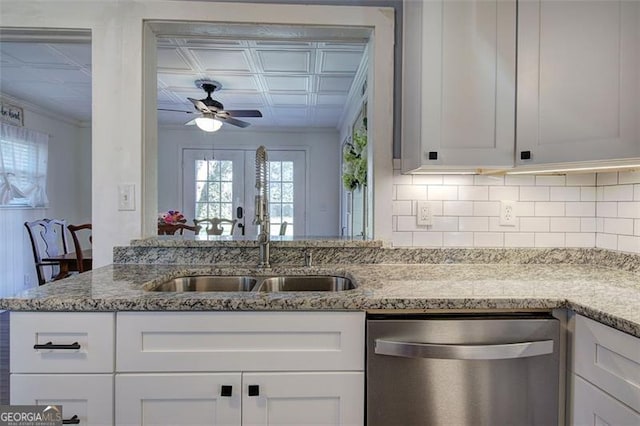 kitchen with a sink, decorative backsplash, light stone countertops, dishwasher, and an ornate ceiling