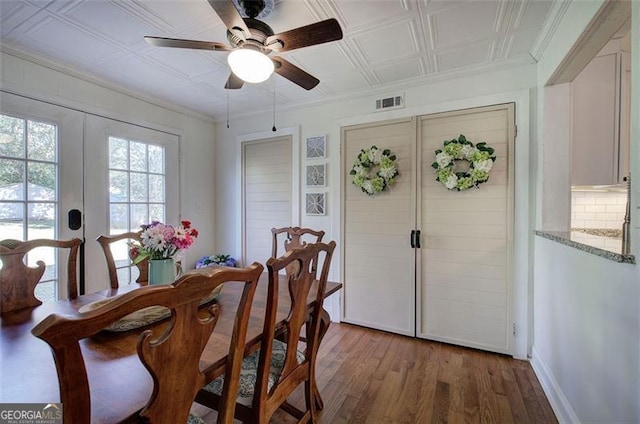 dining space featuring visible vents, an ornate ceiling, ornamental molding, french doors, and light wood-type flooring