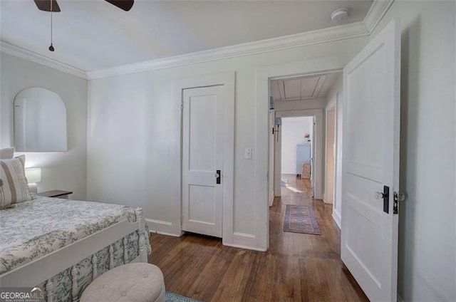 bedroom with dark wood-style floors, attic access, ornamental molding, ceiling fan, and baseboards