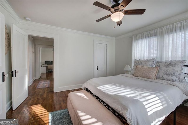 bedroom featuring crown molding, a closet, a ceiling fan, wood finished floors, and baseboards