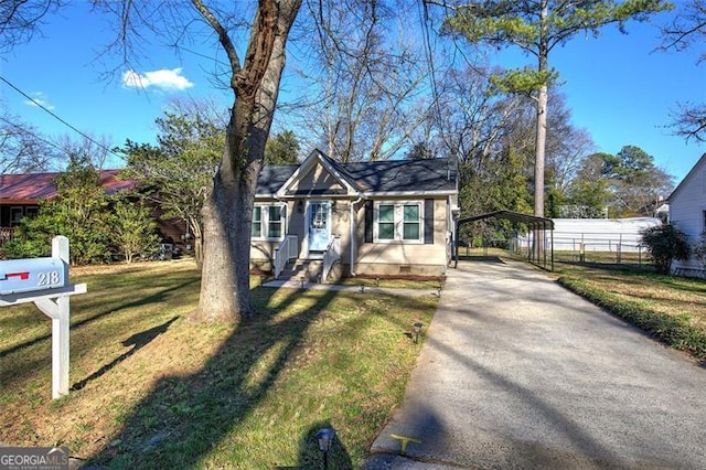 bungalow-style house with fence, concrete driveway, crawl space, a carport, and a front lawn