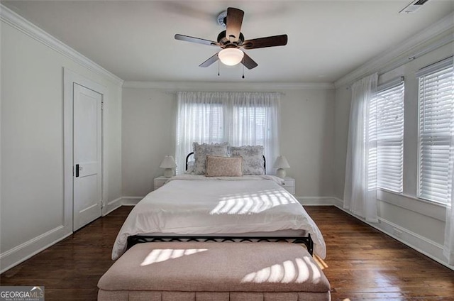 bedroom with a ceiling fan, crown molding, baseboards, and wood finished floors