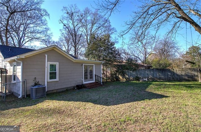 exterior space featuring entry steps, a yard, french doors, and fence