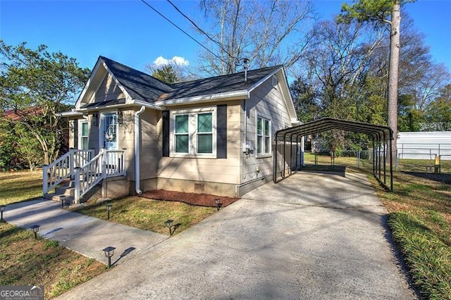 view of home's exterior featuring concrete driveway, crawl space, fence, a yard, and a detached carport