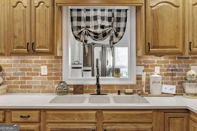 kitchen featuring brown cabinetry and light countertops