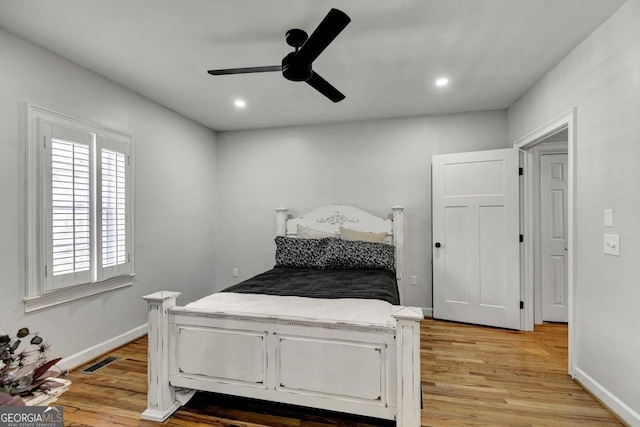 bedroom featuring recessed lighting, visible vents, light wood-style flooring, and baseboards