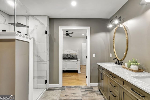 ensuite bathroom featuring walk in shower, a sink, ensuite bathroom, and wood finished floors