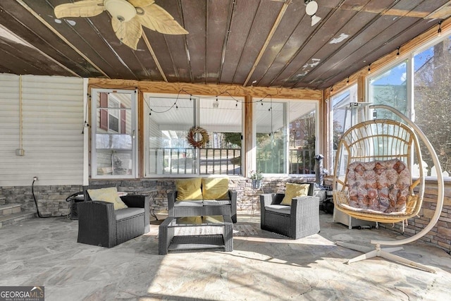 exterior space featuring wood ceiling and a ceiling fan