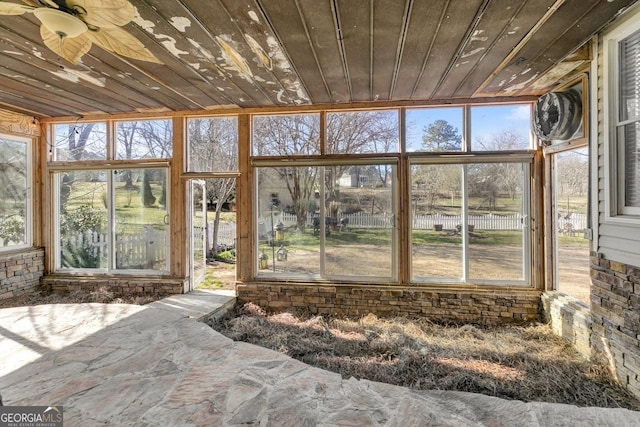 unfurnished sunroom with wood ceiling