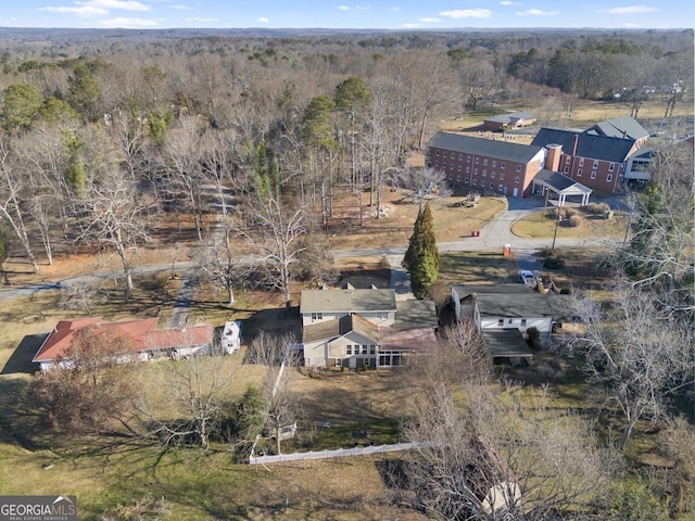 bird's eye view featuring a wooded view