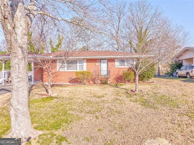 ranch-style home with brick siding and a front lawn