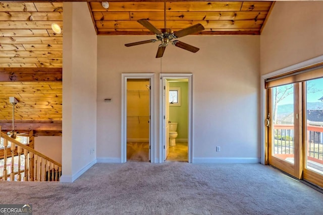 unfurnished bedroom featuring access to exterior, carpet, connected bathroom, and baseboards