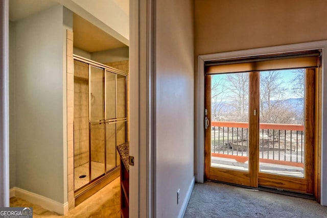 doorway featuring a healthy amount of sunlight and baseboards