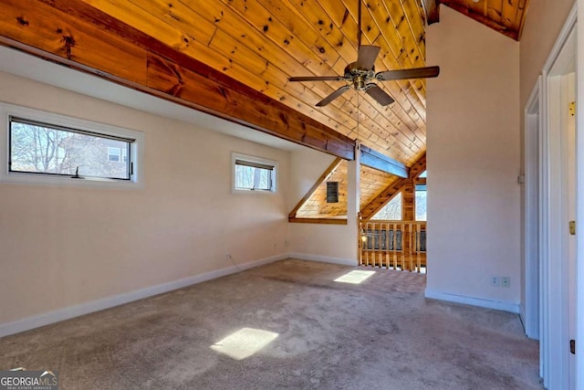 bonus room with baseboards, lofted ceiling with beams, wood ceiling, ceiling fan, and carpet flooring