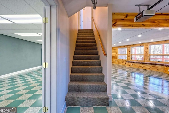 stairway with recessed lighting, a drop ceiling, tile patterned floors, and baseboards