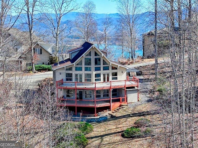 back of property featuring a wooden deck