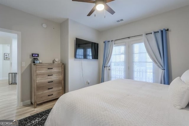 bedroom featuring visible vents, light wood-style flooring, a ceiling fan, access to outside, and baseboards