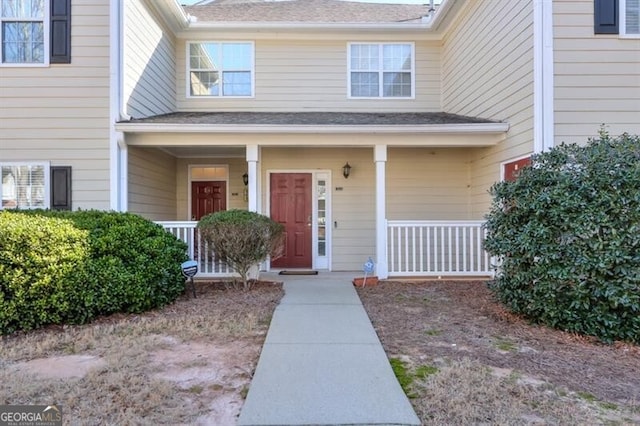 view of exterior entry featuring a porch