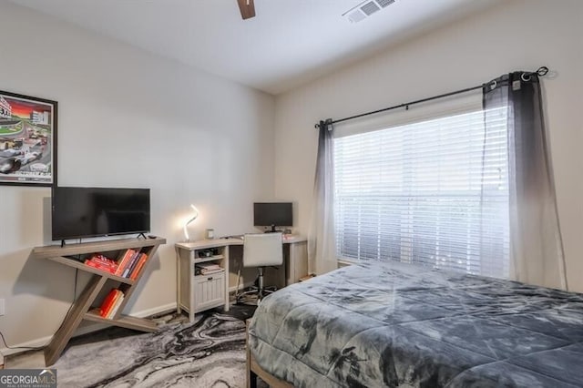 bedroom featuring a ceiling fan, visible vents, and baseboards