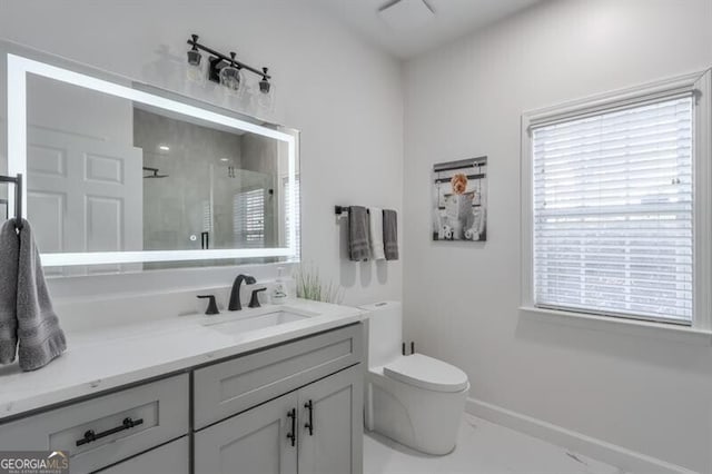 bathroom with a stall shower, baseboards, toilet, marble finish floor, and vanity