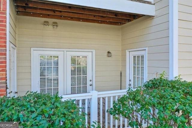 view of exterior entry with brick siding