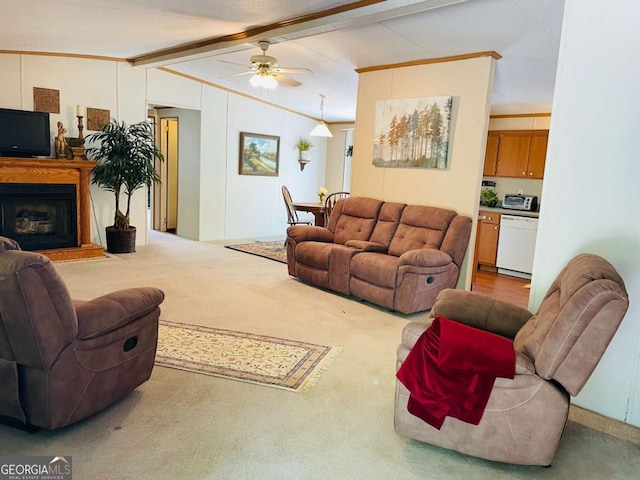 carpeted living area with crown molding, a fireplace with raised hearth, vaulted ceiling with beams, and ceiling fan