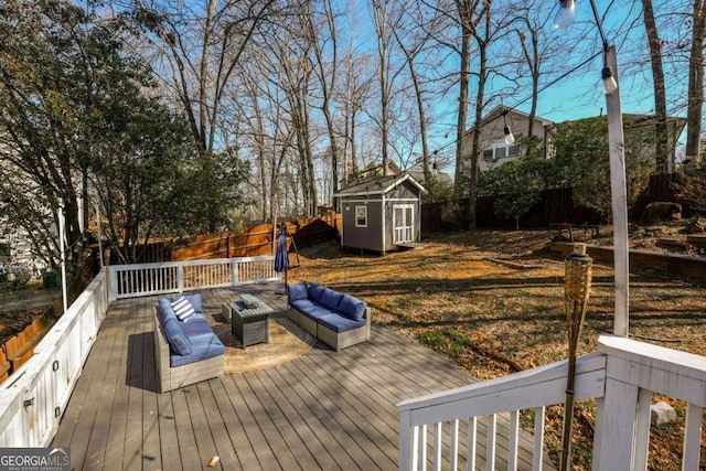 deck featuring a storage unit, an outdoor structure, a fenced backyard, and an outdoor living space