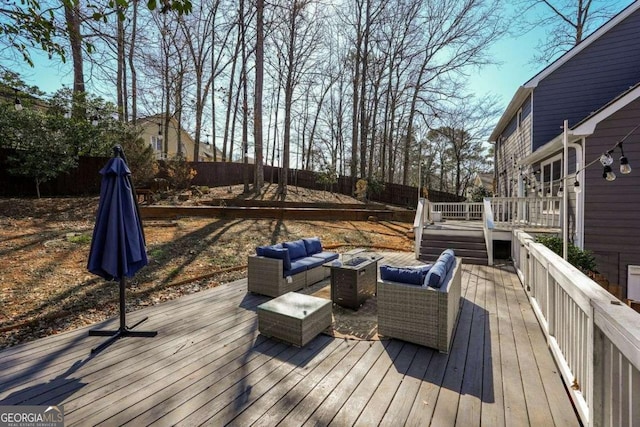 deck with a fenced backyard and an outdoor living space