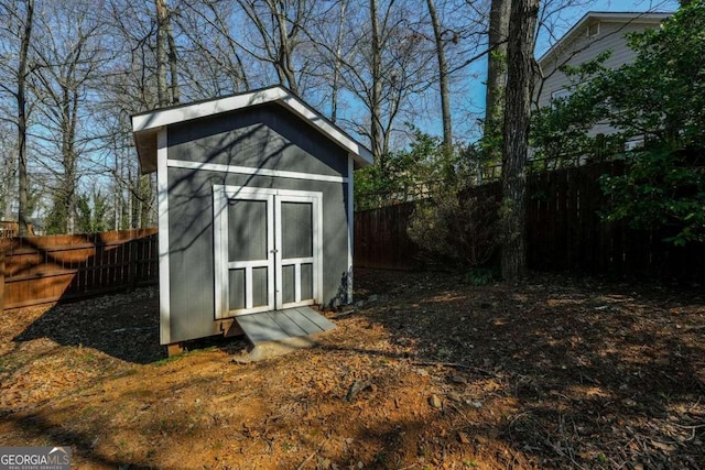 view of shed with a fenced backyard