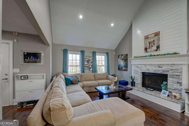 living room featuring high vaulted ceiling, recessed lighting, a fireplace, and wood finished floors