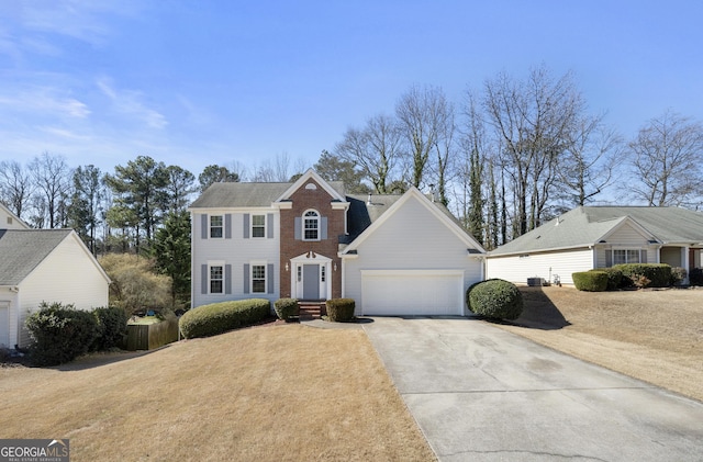 view of front facade featuring driveway, brick siding, and an attached garage