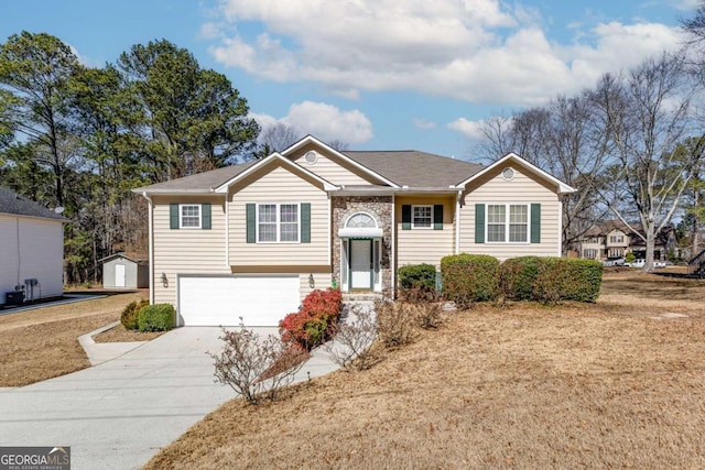 view of front of property featuring concrete driveway and an attached garage