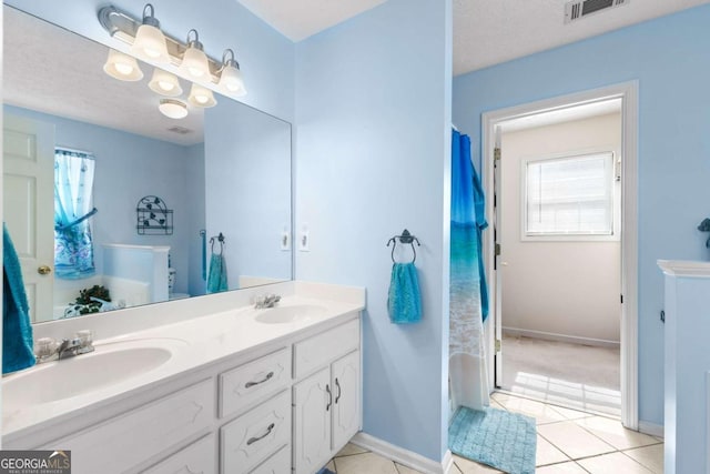 1800 Rockdale Cir, Snellville, GA 30078 - bathroom featuring tile patterned flooring, visible vents, a sink, and double vanity