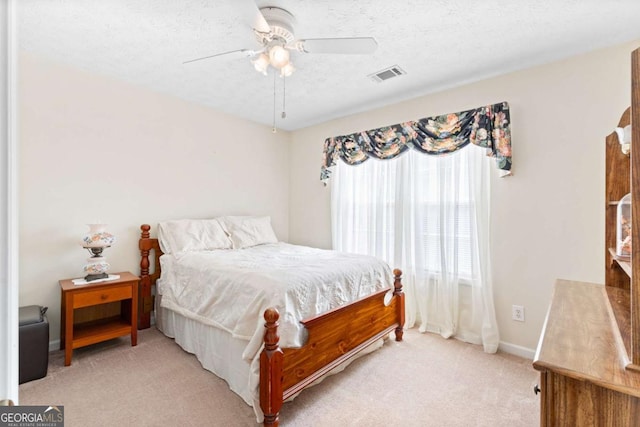 1800 Rockdale Cir, Snellville, GA 30078 - bedroom with visible vents, a ceiling fan, light carpet, a textured ceiling, and baseboards