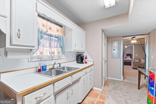 1800 Rockdale Cir, Snellville, GA 30078 - kitchen featuring light countertops, white cabinetry, a sink, and a textured ceiling