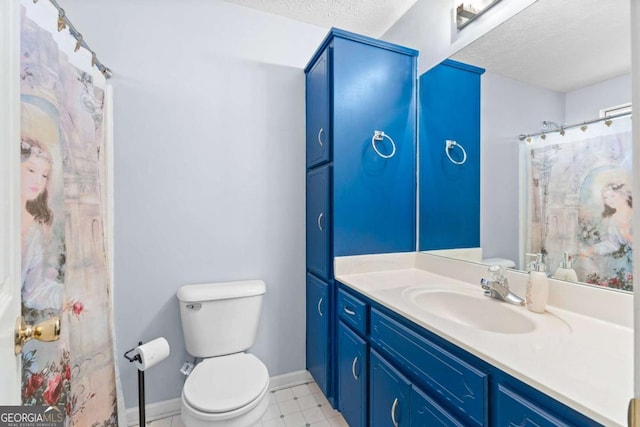 1800 Rockdale Cir, Snellville, GA 30078 - bathroom featuring a textured ceiling, vanity, toilet, and baseboards