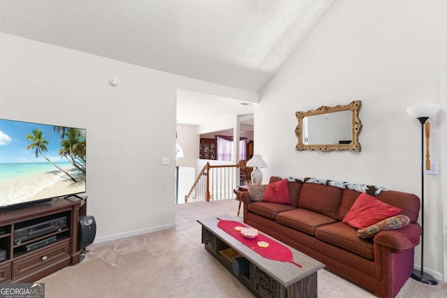 1800 Rockdale Cir, Snellville, GA 30078 - carpeted living area with lofted ceiling, a textured ceiling, and baseboards