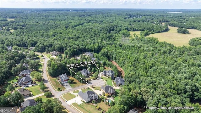 bird's eye view with a wooded view