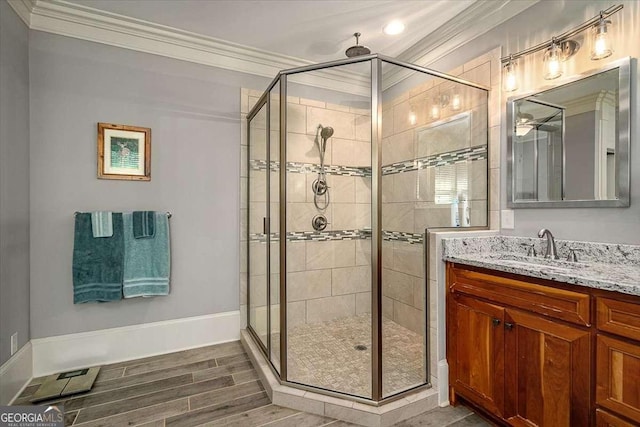 full bath with a shower stall, ornamental molding, wood finished floors, and vanity