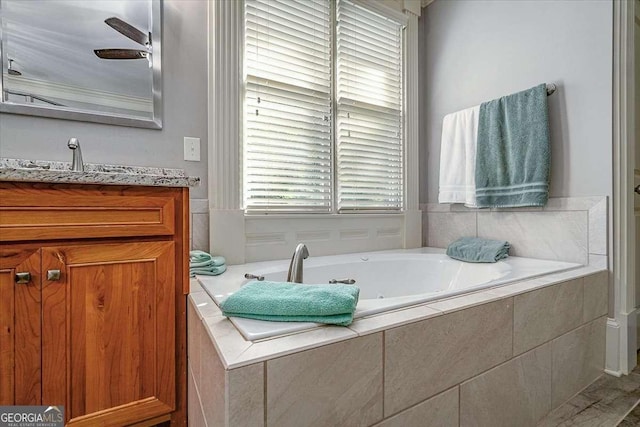 full bathroom featuring a whirlpool tub and vanity