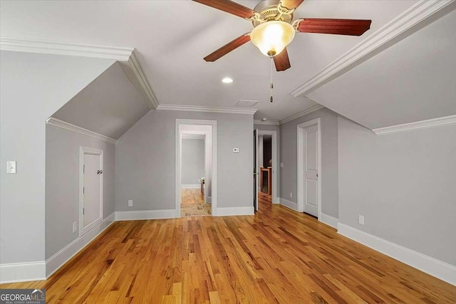 additional living space featuring light wood finished floors, visible vents, baseboards, and ceiling fan