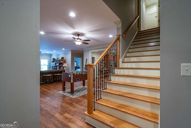 staircase featuring ornamental molding, wood finished floors, a ceiling fan, and recessed lighting