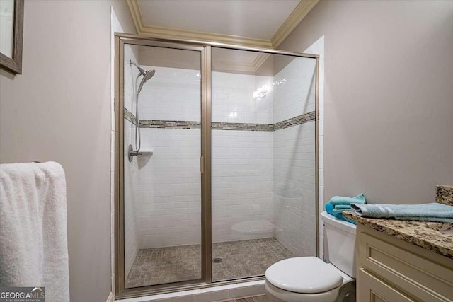 bathroom featuring vanity, a shower stall, toilet, and crown molding