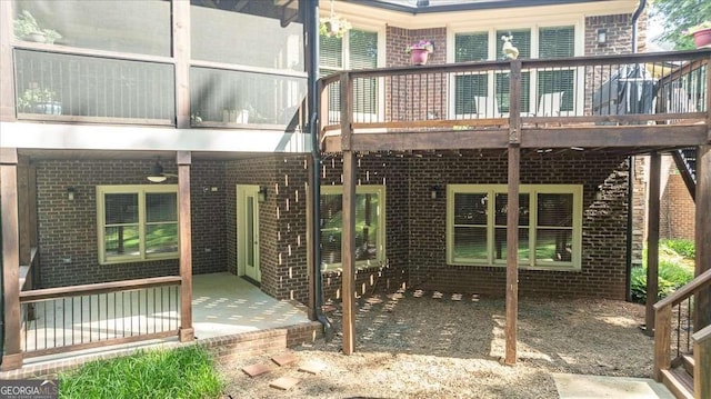 back of house with a patio, brick siding, and a ceiling fan