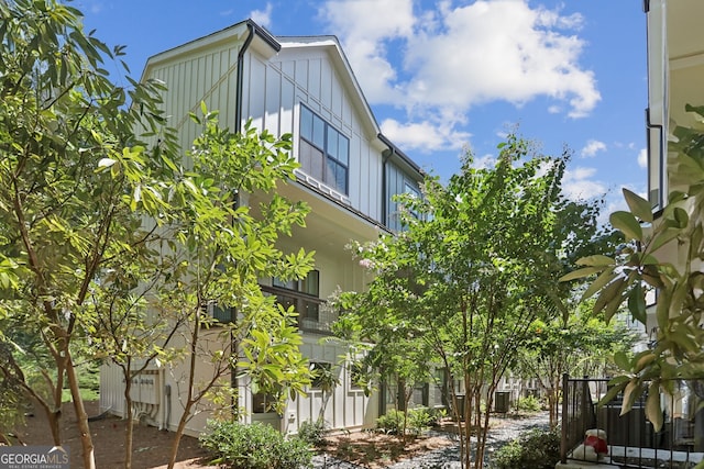 view of property exterior featuring fence and board and batten siding