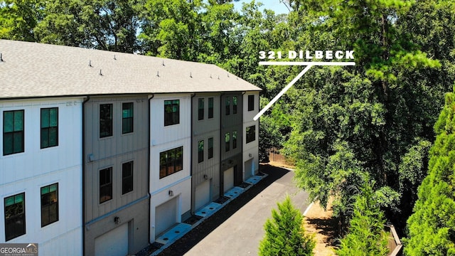 view of home's exterior featuring roof with shingles